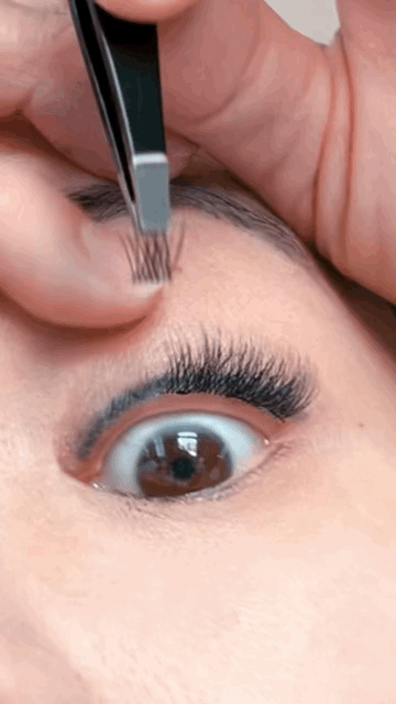 close up of woman applying diy lash extensions
